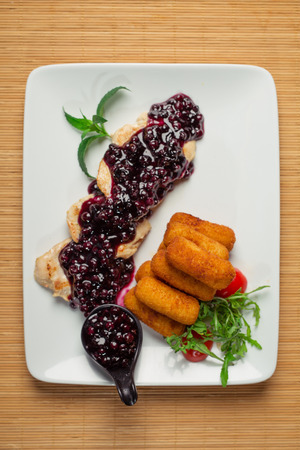 Fried crispy chicken nuggets with blackberry sauceの写真素材