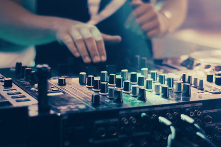 DJ playing music at mixer closeupの写真素材
