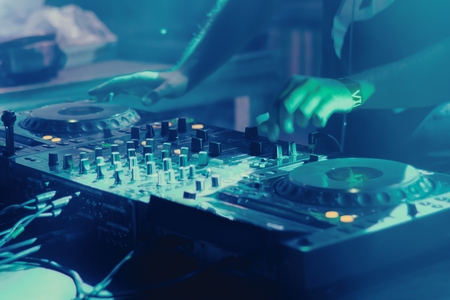 DJ playing music at mixer closeupの写真素材