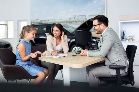 Top sales manager and customer at dealership showroomの写真素材