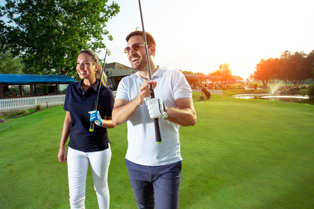 Couple at the course playing golf and looking happyの写真素材