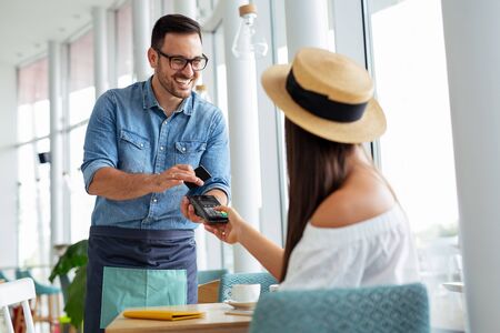 Customer paying his bills using credit cardの写真素材