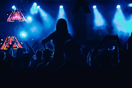 People dancing and cheering at music festival