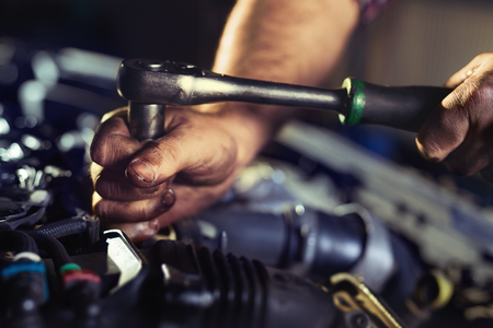 Hands of mechanic working in auto repair shopの写真素材