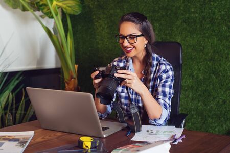 Engineer looking at photos that she took on camera that morning.の写真素材