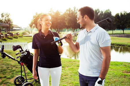 Couple at the course playing golf and looking happyの写真素材