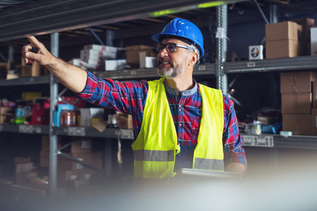 Male warehouse worker with clipboardの写真素材