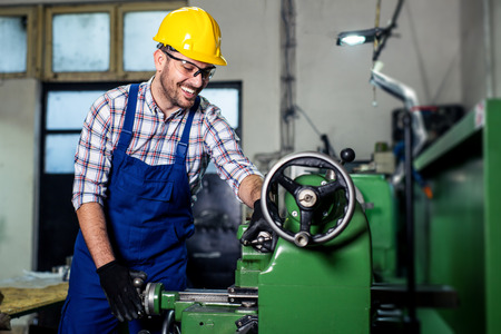 Turner worker is working on a lathe machine in a factoryの写真素材