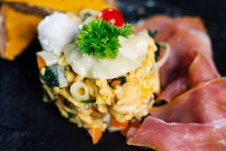 Delicious egg with ham. Cheese and vegetables.