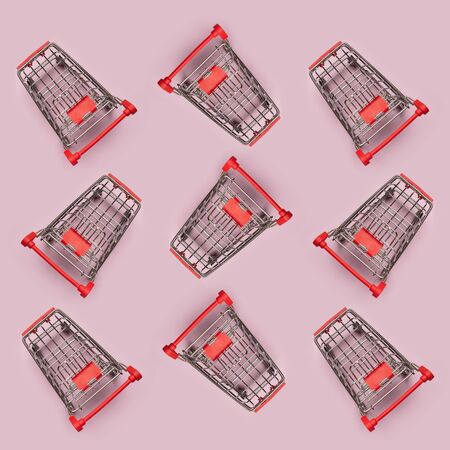Pattern of many small shopping carts. Minimalism flat lay top viewの写真素材