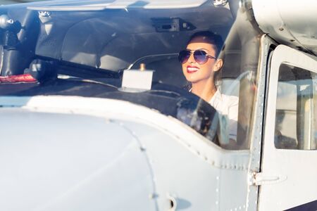 Female pilot preparing for a flight in a light aircraft