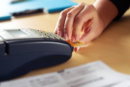 Woman pay with credit card. POS terminal with credit card.