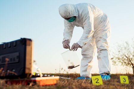 Criminologist investigates a crime scene.の写真素材
