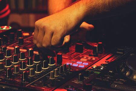 DJ playing music at mixer closeup