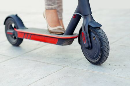 Business woman on the electric scooter on the road.の写真素材