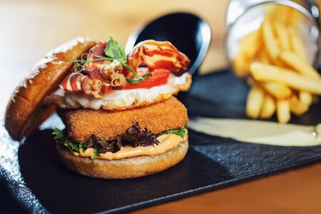 Hamburger with fish cutlet and vegetables.の写真素材