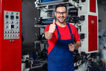 Industrial worker thumb up in factory.   Man in Industrial Environment.