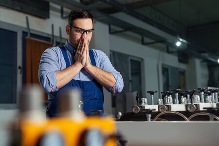 Industrial worker being worried for bad results in production.の写真素材