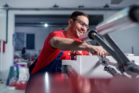 Industrial machine operator working in factory.