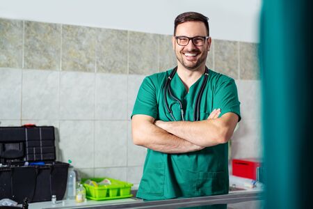 Portrait of veterinarian standing crossed arms at veterinary clinic.の写真素材