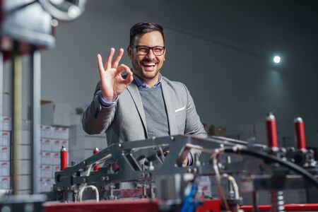 Industrial worker thumb up in factory.   Man in Industrial Environment.
