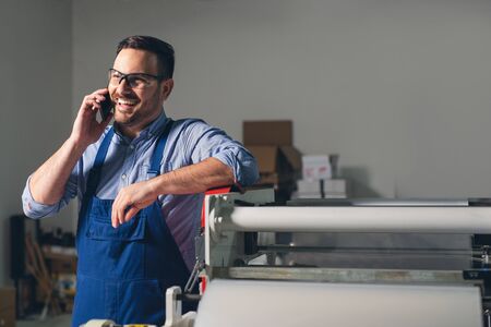 Industrial worker talking on cell phone.