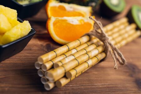 Healthy food and ingredients and paper straws painted to look like bamboo straws.