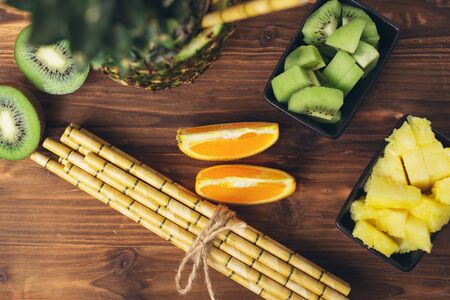 Healthy food and ingredients and paper straws painted to look like bamboo straws.