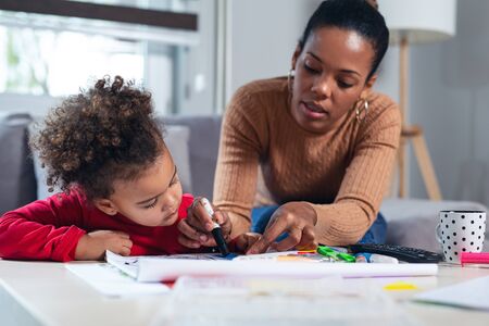 Happy family. Mother and daughter together paint.の写真素材
