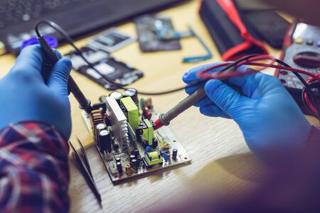 Professional repairman repairing computer in workshop.の写真素材