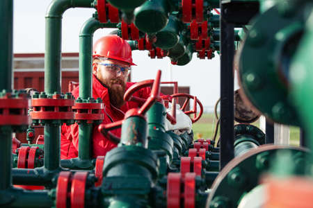 Oil worker turning valve on oil rigの写真素材