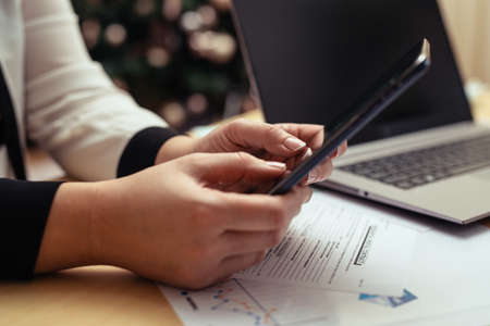 Woman with bills and smart phone at the table