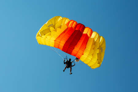 Parachute in the sky. Skydiver is flying a parachute in the blue sky.