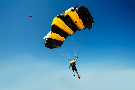 Parachute in the sky. Skydiver is flying a parachute in the blue sky.