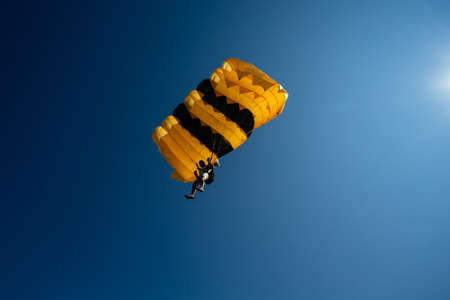 Parachute in the sky. Skydiver is flying a parachute in the blue sky.