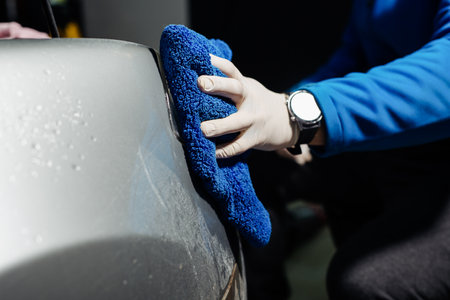 Cleaning headlight with microfiber cloth, car lightsの写真素材