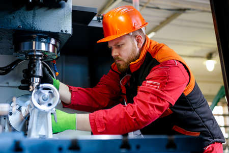 Quality control manufacturing.Hands of an engineer measures a metal part with a digital vernier...