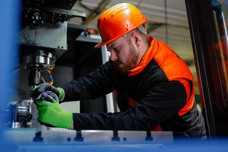 Quality control manufacturing.Hands of an engineer measures a metal part with a digital vernier...