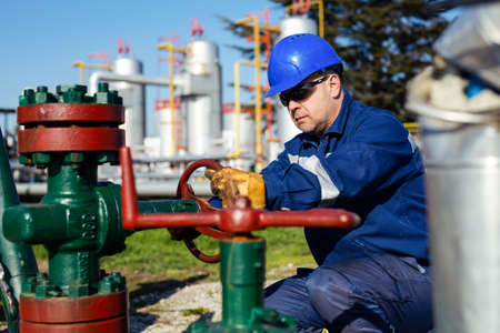 Two Factory worker in a hard hat on Heavy equipment and pipeline