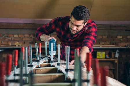 Carpenter assembling new wooden canoe of their own designの写真素材