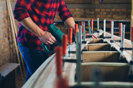 Carpenter assembling new wooden canoe of their own designの写真素材