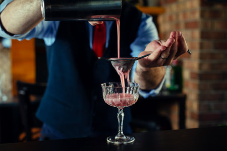 Bartender serve cocktail drink for customer at the barの写真素材