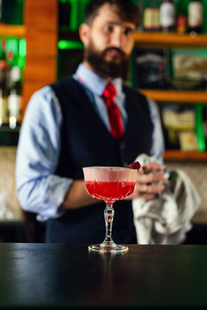 Bartender serve cocktail drink for customer at the bar