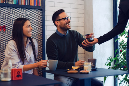 Man paying bill at fancy restaurant
