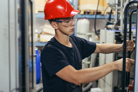 Working atmosphere in metal sheet factory with large industrial machines.の写真素材