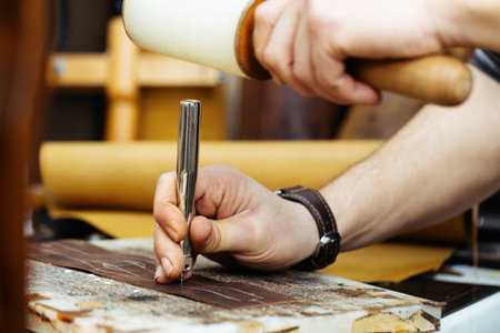Close-up of the hands of a shoemaker at work.