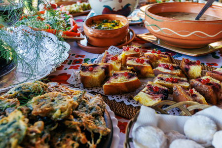 Traditional romanian food displaying on table at a festive event, showcasing variety of dishes and dessertsの写真素材