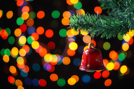 Christmas decoration on a fir tree with blured lights in backgroundの写真素材