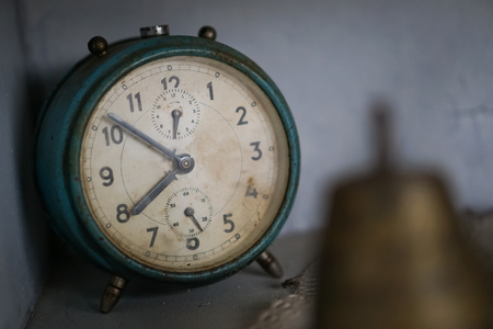 Old dusty analog table clockの写真素材