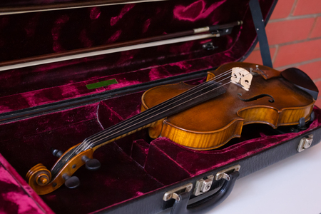 Violin and bow in dark red case. Close upの写真素材